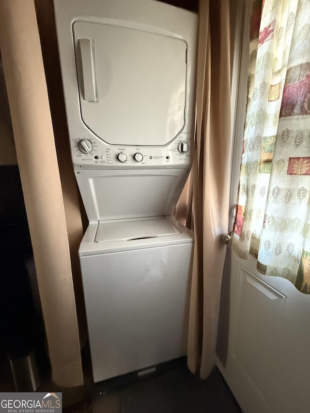 laundry room with stacked washer / drying machine