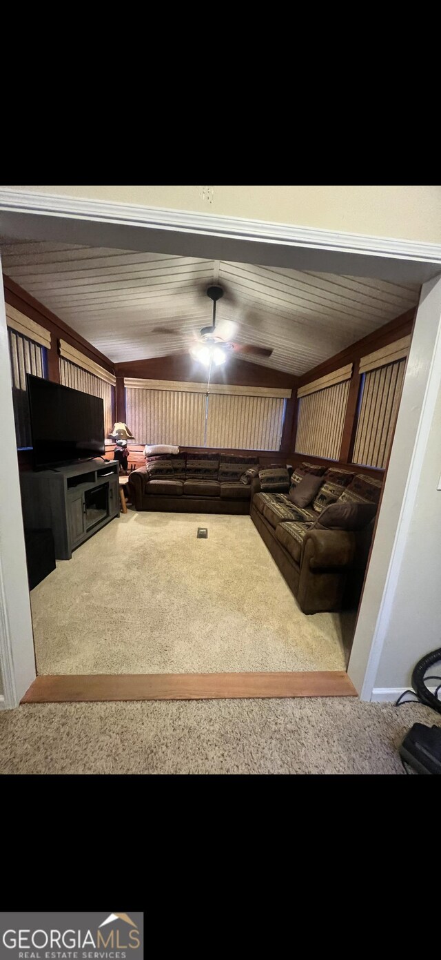 unfurnished living room featuring ceiling fan and carpet floors