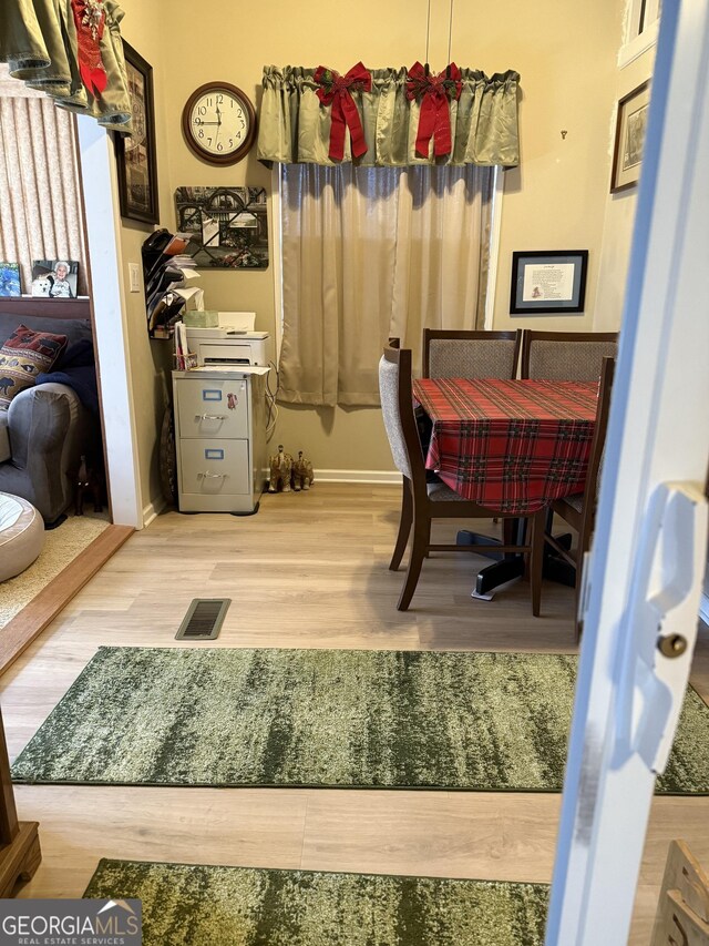 dining area with hardwood / wood-style floors