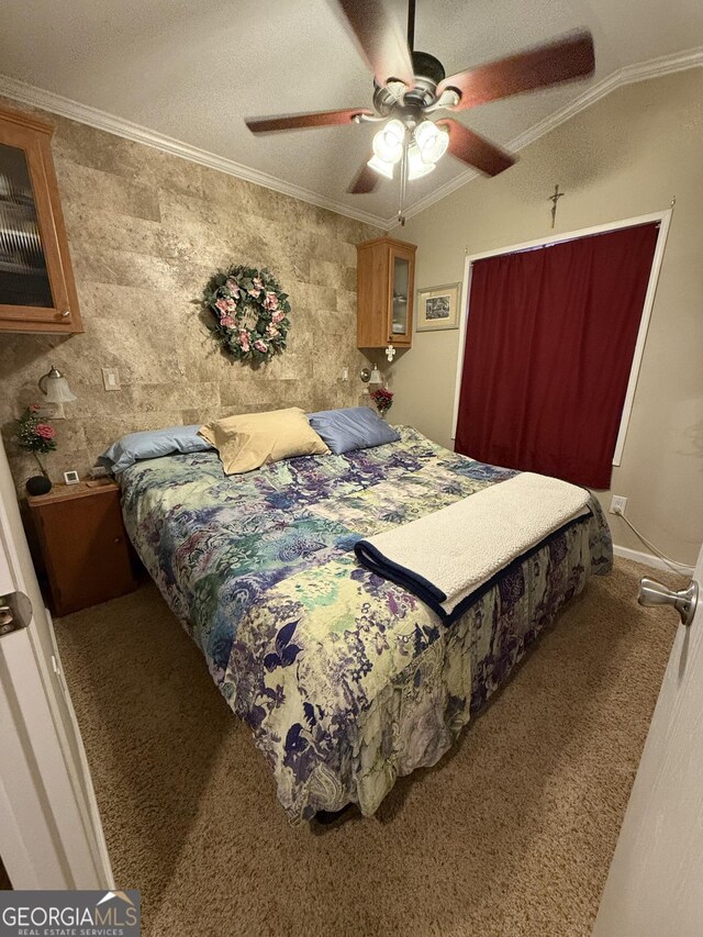 bedroom with ceiling fan, carpet floors, crown molding, and lofted ceiling