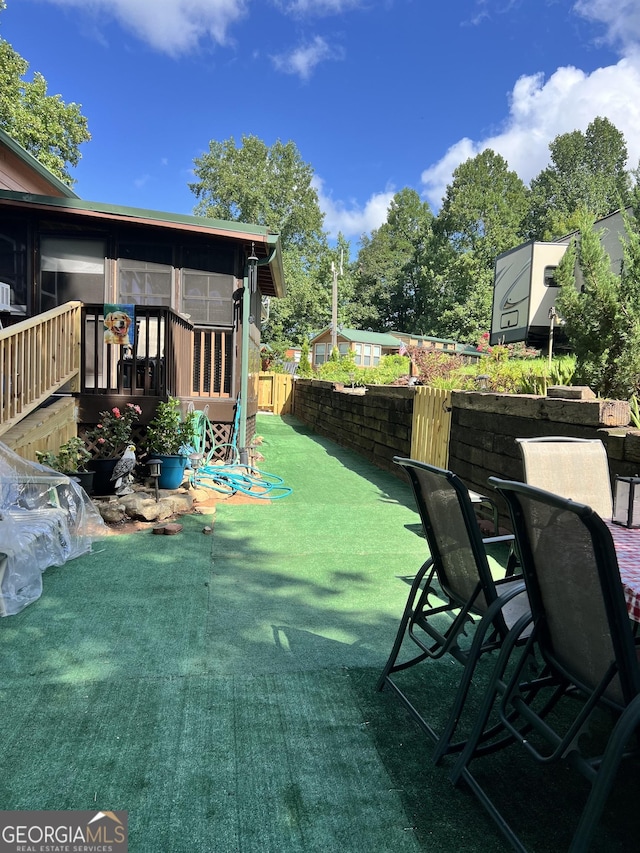 view of patio with a sunroom