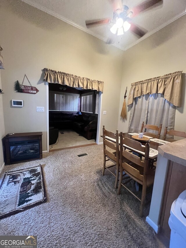 bedroom with a textured ceiling, carpet floors, ceiling fan, and ornamental molding