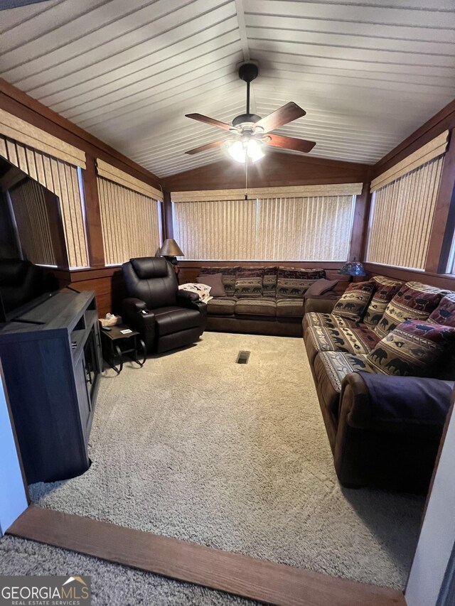 living room featuring ceiling fan, carpet, and vaulted ceiling