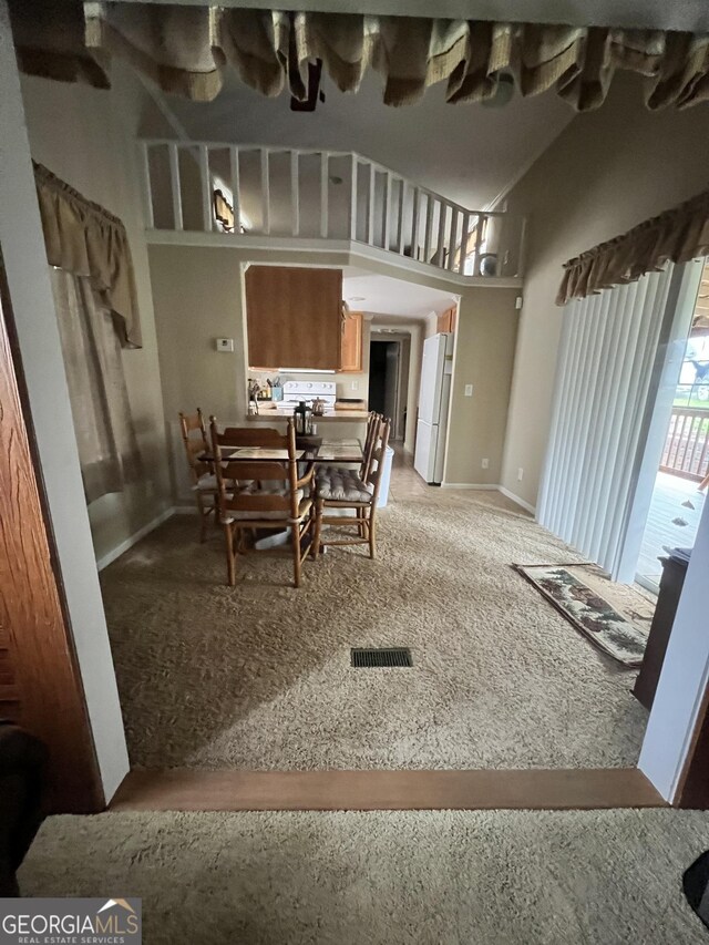 dining area with vaulted ceiling