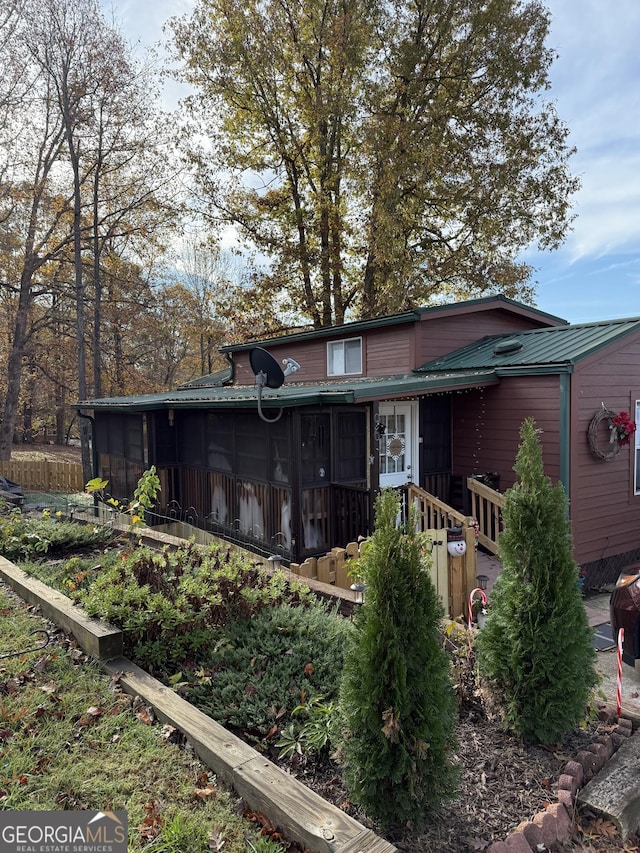 view of front of house with a sunroom