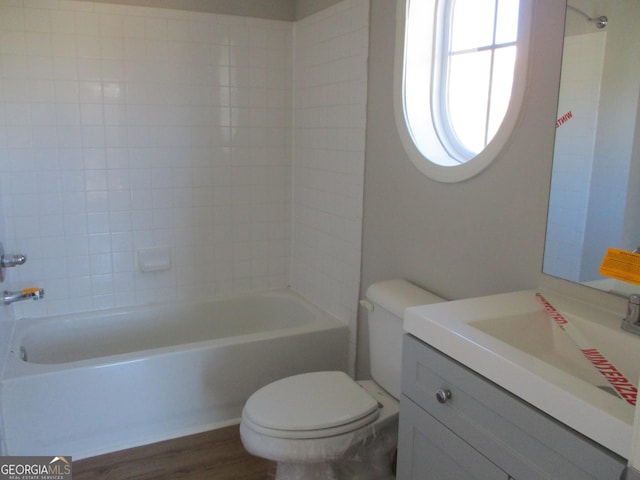 full bathroom featuring shower / tub combination, vanity, hardwood / wood-style flooring, and toilet