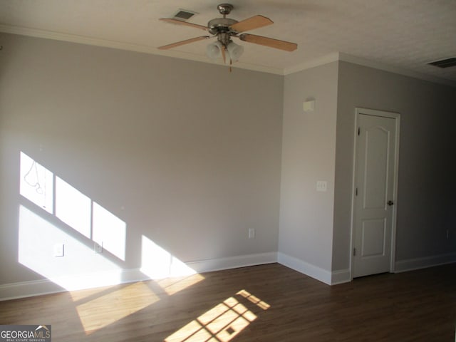 spare room featuring crown molding, ceiling fan, and dark hardwood / wood-style floors