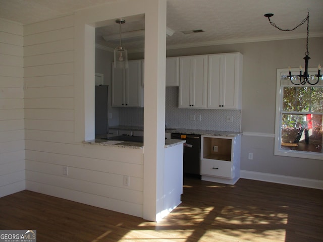 kitchen with decorative backsplash, stainless steel fridge, light stone countertops, a notable chandelier, and white cabinets