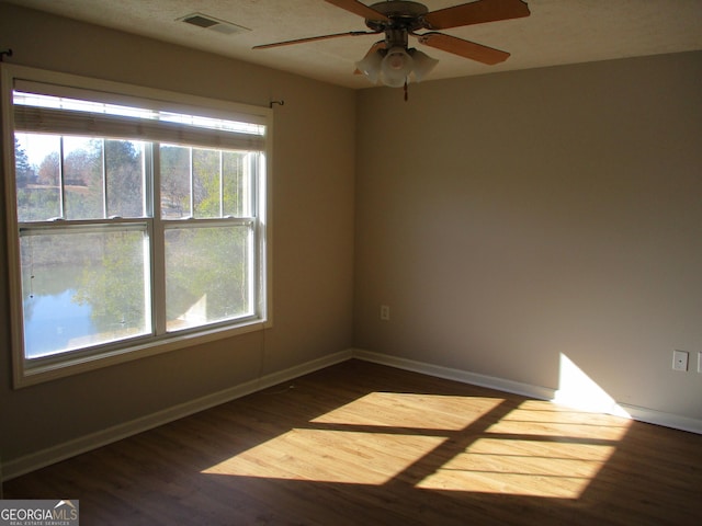 spare room featuring ceiling fan and hardwood / wood-style flooring