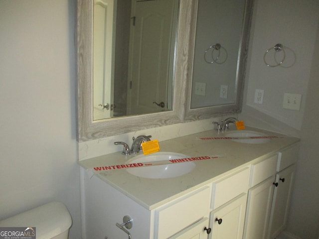 bathroom featuring vanity and toilet