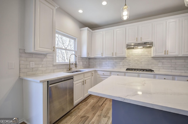 kitchen featuring appliances with stainless steel finishes, white cabinets, and sink