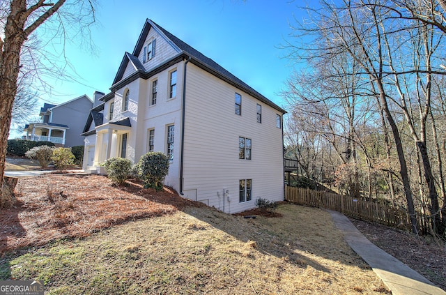 view of side of property with a lawn