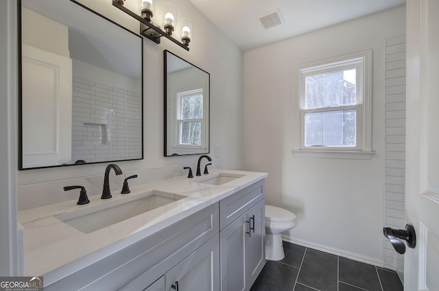 bathroom featuring toilet, tile patterned floors, and vanity