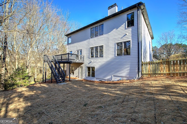 rear view of house with a wooden deck