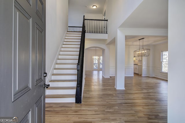 entryway featuring a healthy amount of sunlight, hardwood / wood-style floors, and ornamental molding