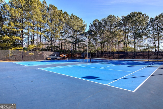 view of tennis court with basketball hoop