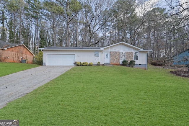 single story home featuring a garage, central air condition unit, and a front yard