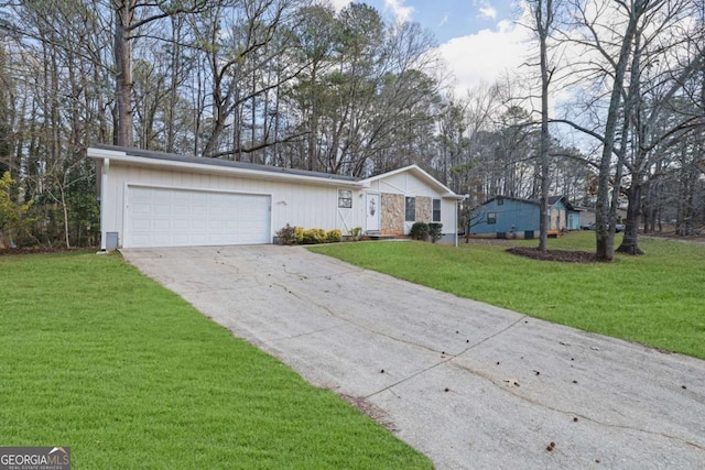 single story home featuring a garage and a front lawn