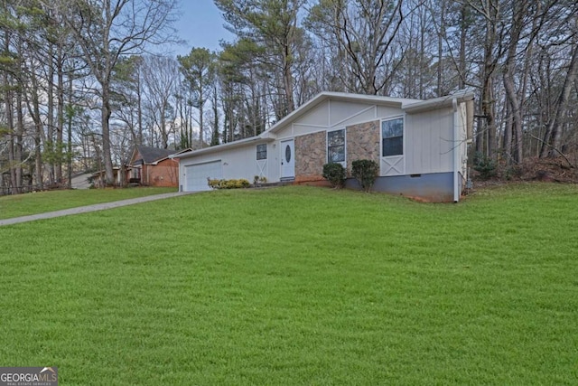 single story home with a garage and a front lawn