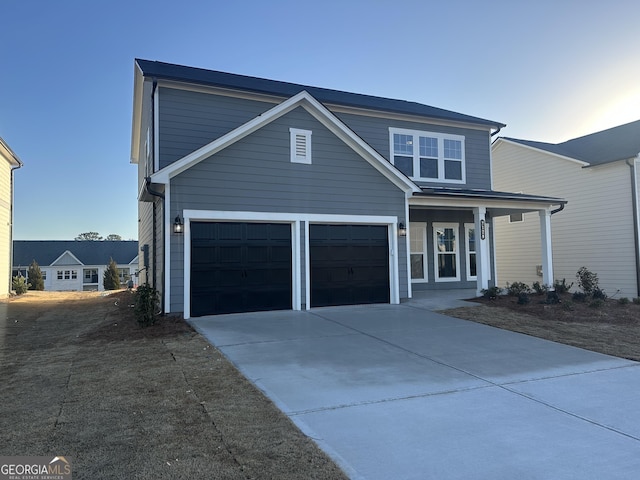 view of property with a garage and a porch