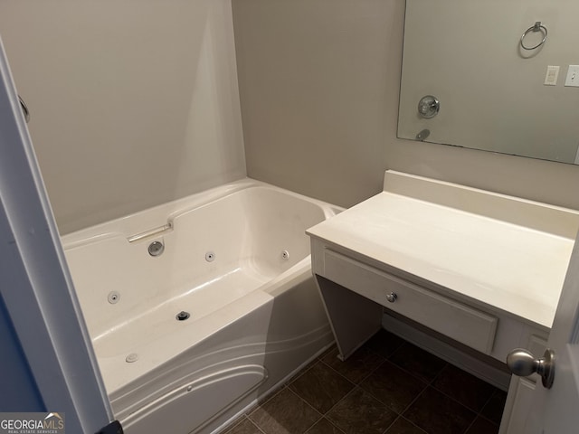 bathroom with a bathing tub, tile patterned flooring, and vanity