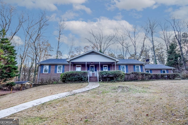 single story home with a front yard and covered porch