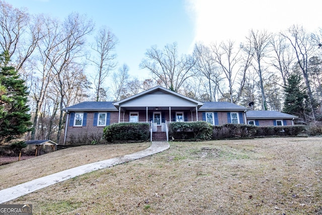 ranch-style home with a front yard and a porch