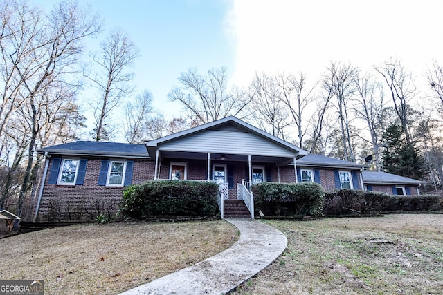 ranch-style home with a porch and a front yard