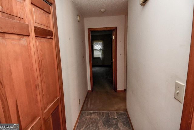 corridor with a textured ceiling