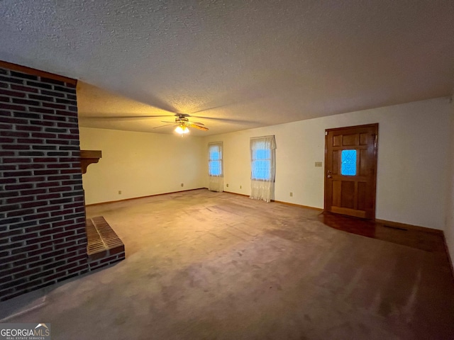 unfurnished living room with carpet floors, a textured ceiling, and ceiling fan