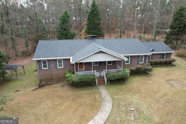 ranch-style house featuring a front lawn and a porch