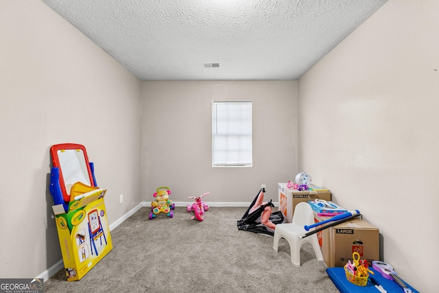 game room featuring carpet floors and a textured ceiling