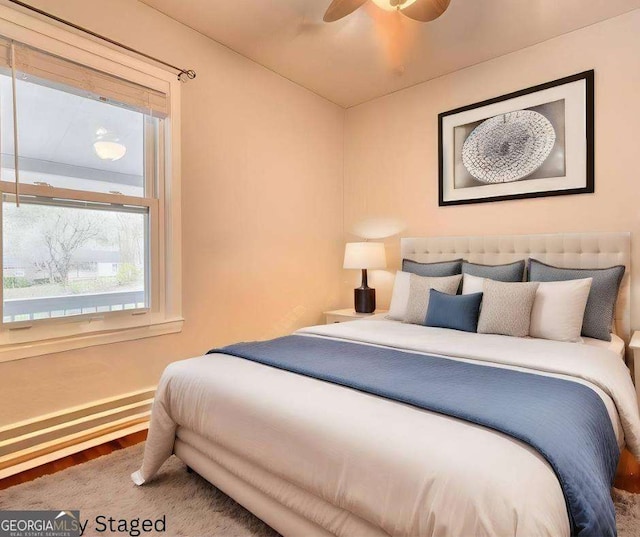 bedroom featuring hardwood / wood-style floors and ceiling fan