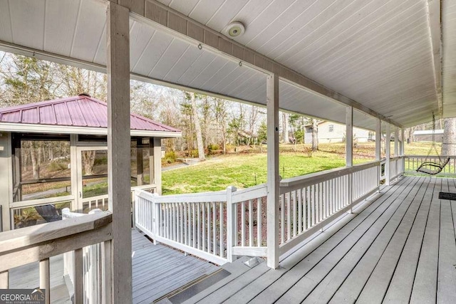 wooden deck featuring a lawn