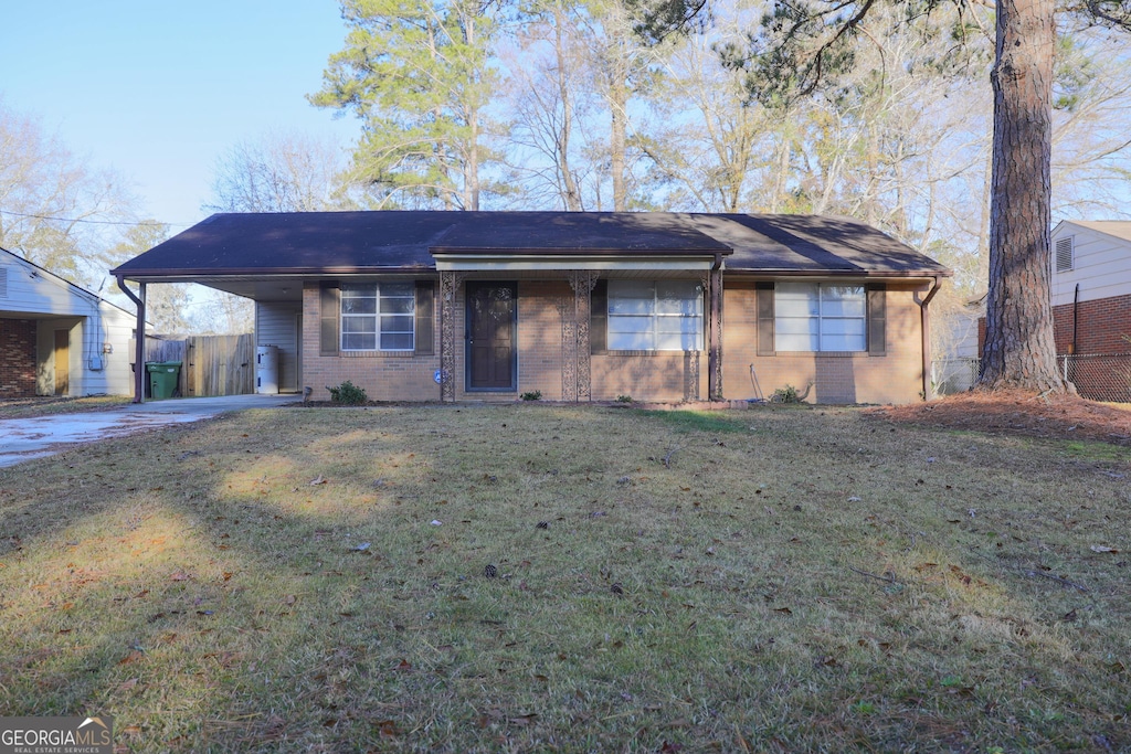 single story home with a front yard and a carport