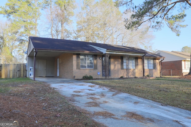 ranch-style house featuring a carport and a front yard