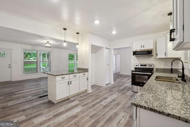 kitchen with sink, white cabinetry, hanging light fixtures, and appliances with stainless steel finishes