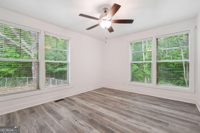 unfurnished room featuring ceiling fan and hardwood / wood-style flooring