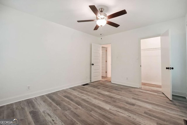 unfurnished bedroom featuring ceiling fan, a closet, and light hardwood / wood-style floors