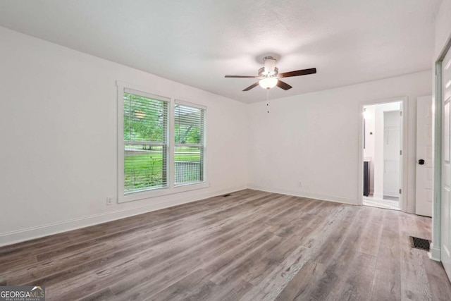 spare room with ceiling fan and hardwood / wood-style floors