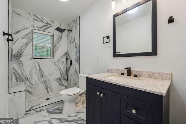 bathroom with vanity, toilet, and a tile shower