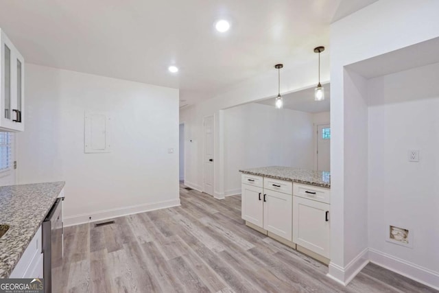 kitchen featuring dishwasher, light wood-type flooring, decorative light fixtures, light stone counters, and white cabinetry