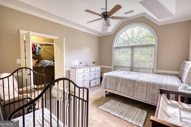 bedroom with light colored carpet, ceiling fan, crown molding, a closet, and lofted ceiling