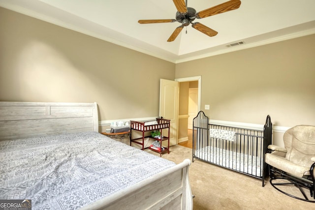 carpeted bedroom with ceiling fan and crown molding