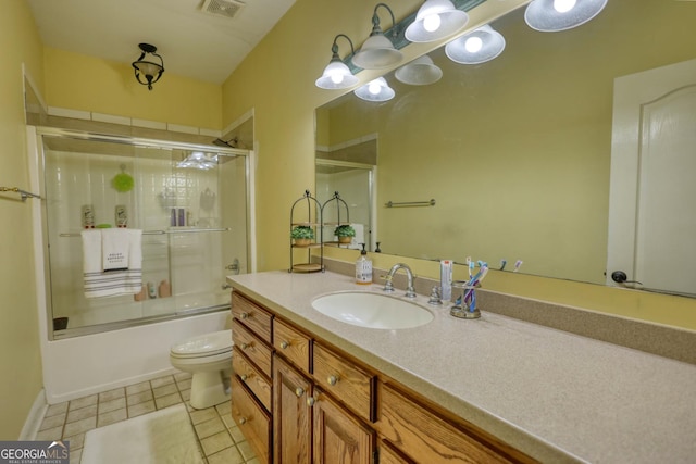 full bathroom with tile patterned flooring, vanity, toilet, and combined bath / shower with glass door