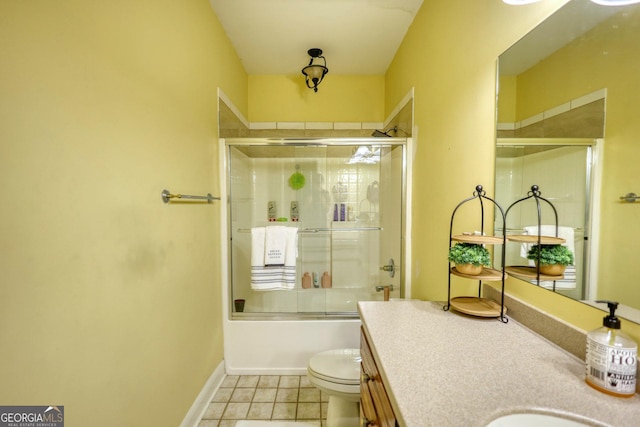 full bathroom with toilet, vanity, tile patterned floors, and enclosed tub / shower combo