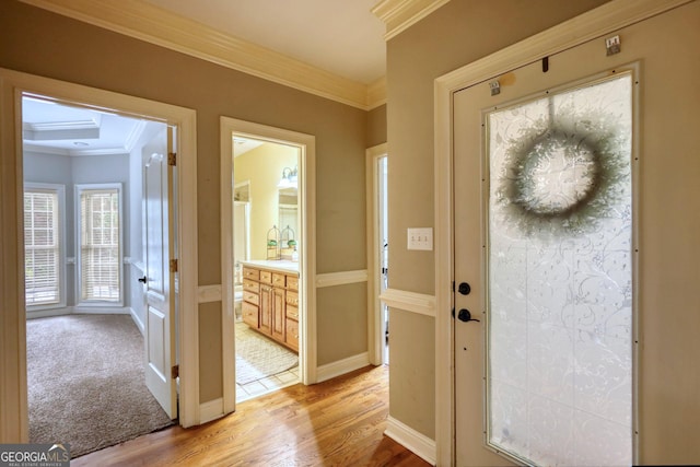 doorway featuring french doors, crown molding, and light hardwood / wood-style flooring