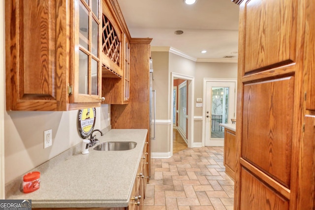 kitchen with crown molding and sink