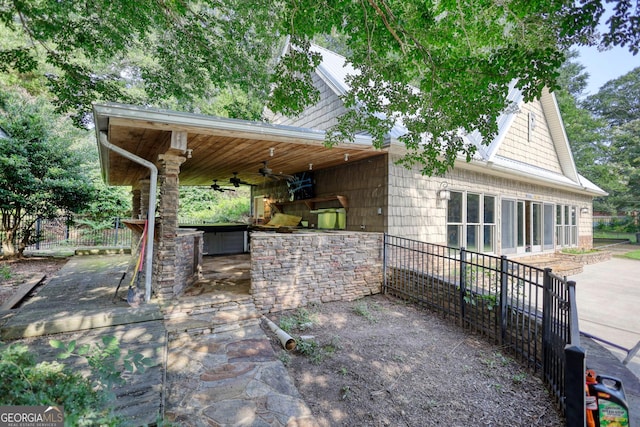 view of patio with area for grilling and ceiling fan