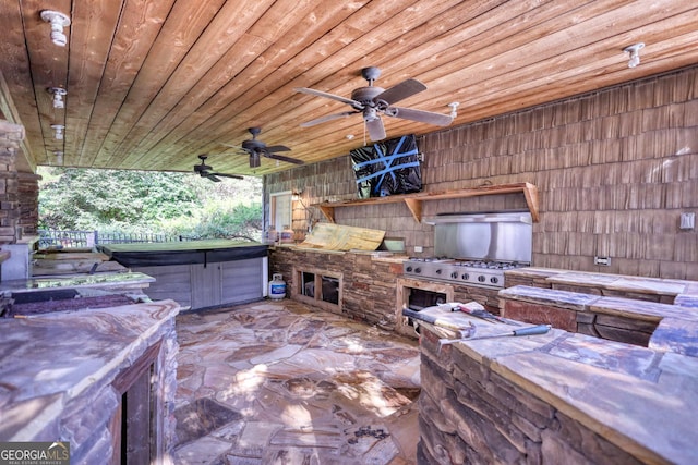 view of patio featuring ceiling fan and exterior kitchen